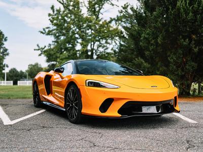 Orange McLaren supercar full front view demonstrating luxury car detailing services